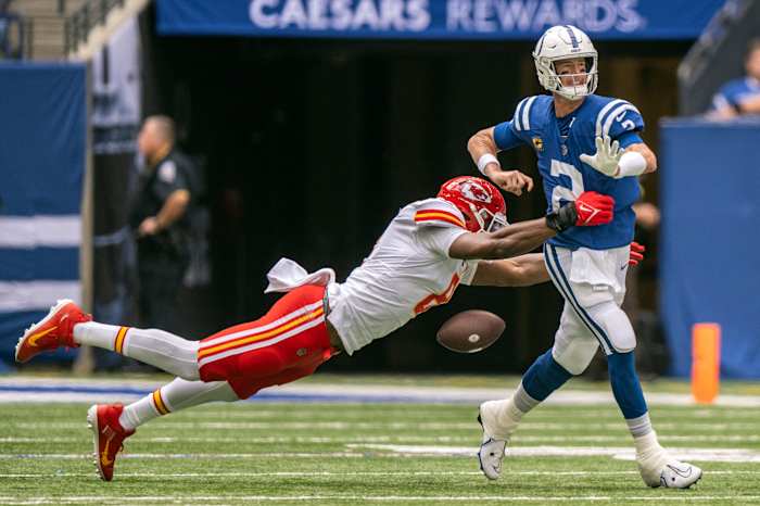 Sep 25, 2022; Indianapolis, Indiana, USA; Indianapolis Colts quarterback Matt Ryan (2) fumbles the ball while being sacked by Kansas City Chiefs defensive end Carlos Dunlap (8) during the second quarter at Lucas Oil Stadium. Mandatory Credit: Marc Lebryk-USA TODAY Sports